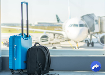 suitcases with an airplane in the background