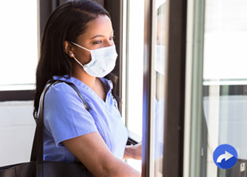 masked patient walking out door