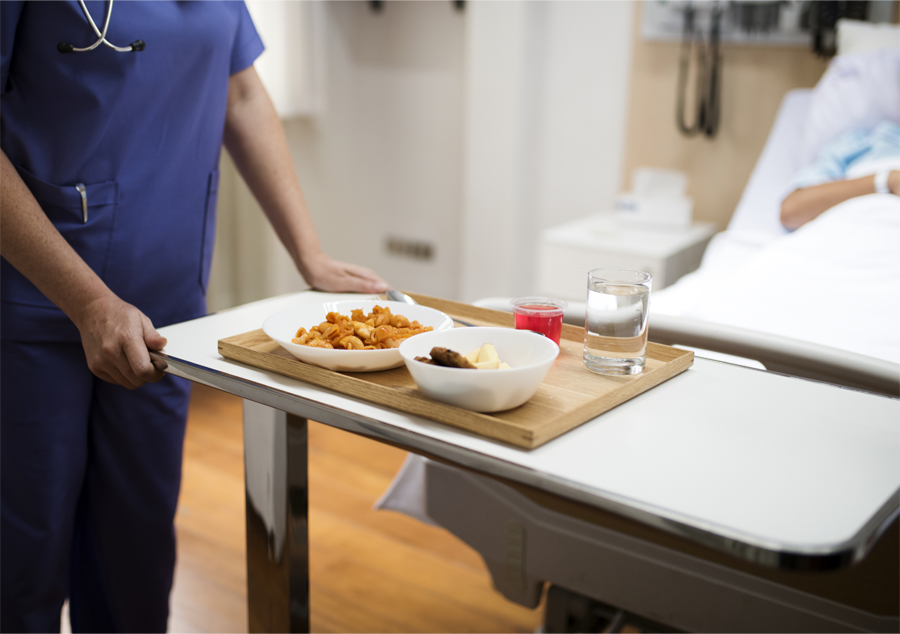nutrition staff serving meal to patient