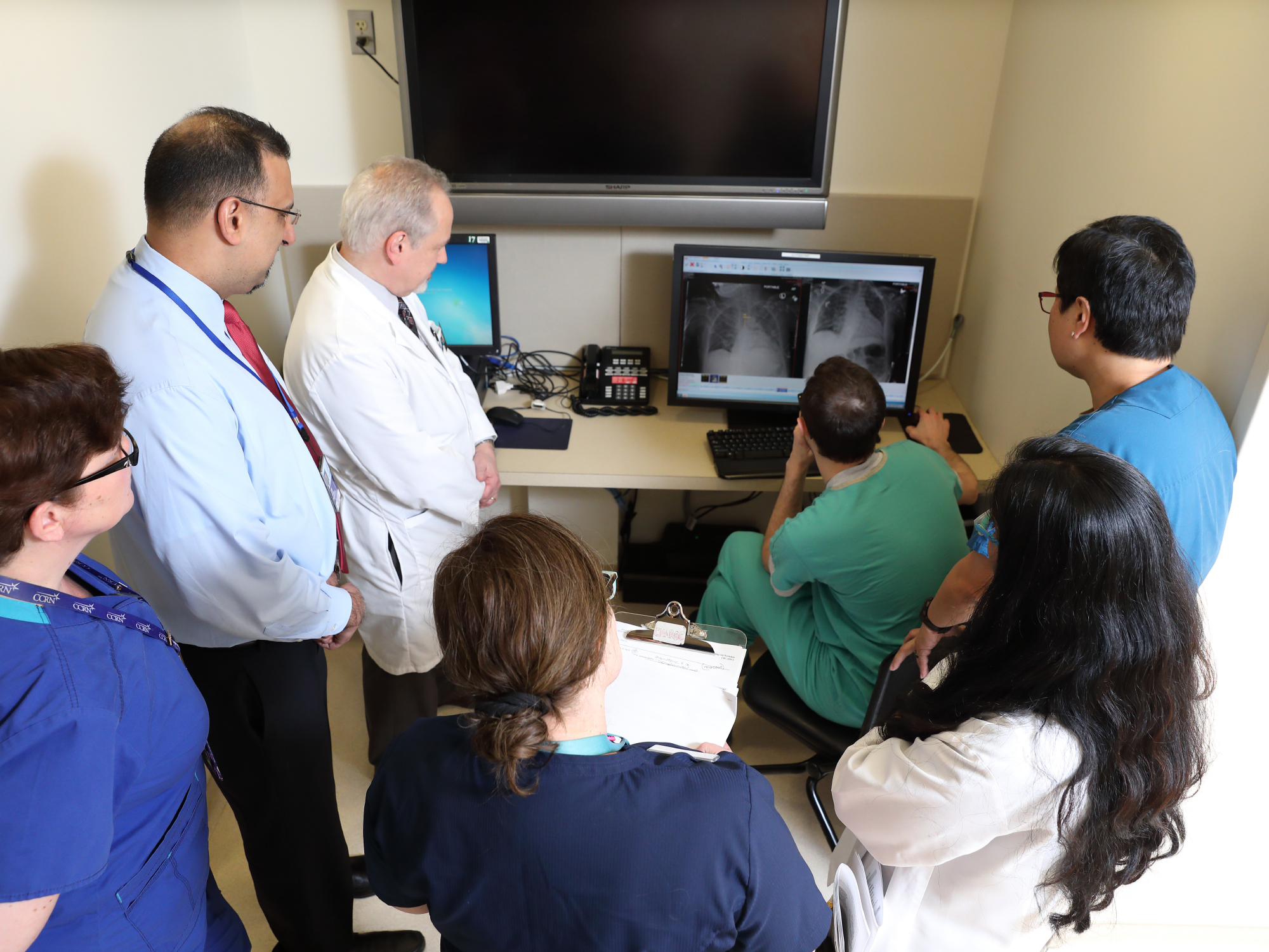 group of doctors and fellows looking at a scan