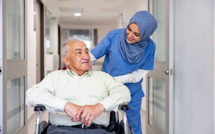 nurse helps patient in a wheelchair