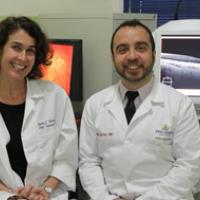 A photograph of Dr. Rachel Bishop and Dr. Allen Eghrari, from the Johns Hopkins University Wilmer Eye Institute, shown with the advanced imaging technologies being used for the PREVAIL III study in Monrovia, Liberia.