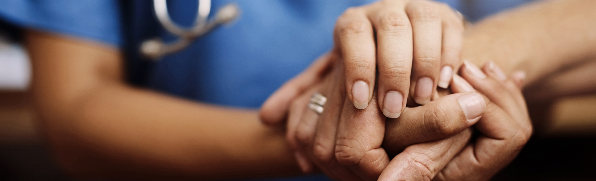 healthcare provider holding a patient's hand