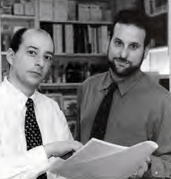 “Drs. Stephen Piscitelli (left) and Aaron Burstein (right) discuss the results of their drug-interaction study involving St. John’s wort.