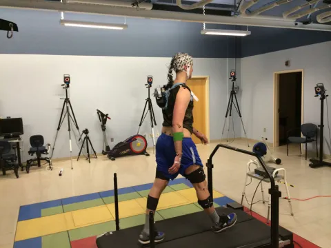 A participant walks on the active treadmill while EEG is recorded.