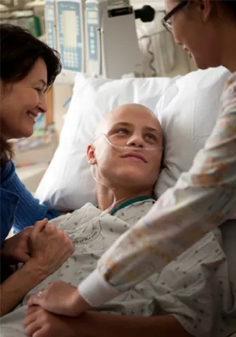 patient in a hospital bed looks at his caregiver